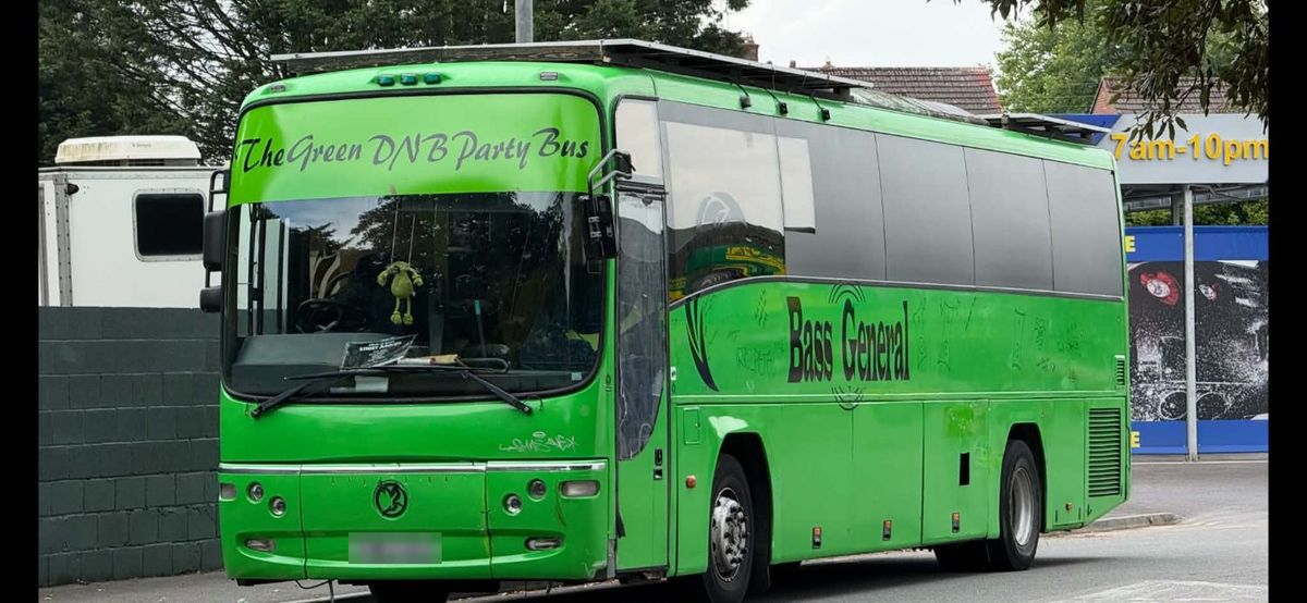 The lime-green coach with The Green DNB Party Bus hand-lettered across the windscreen